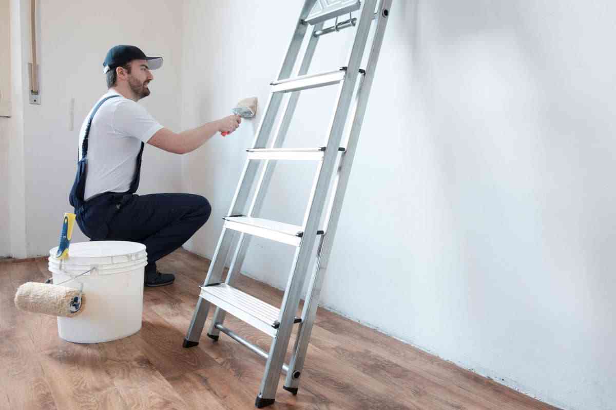 man painting wall