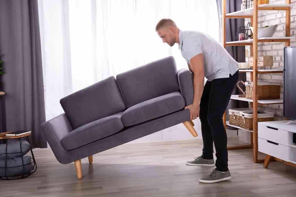 man lifting couch