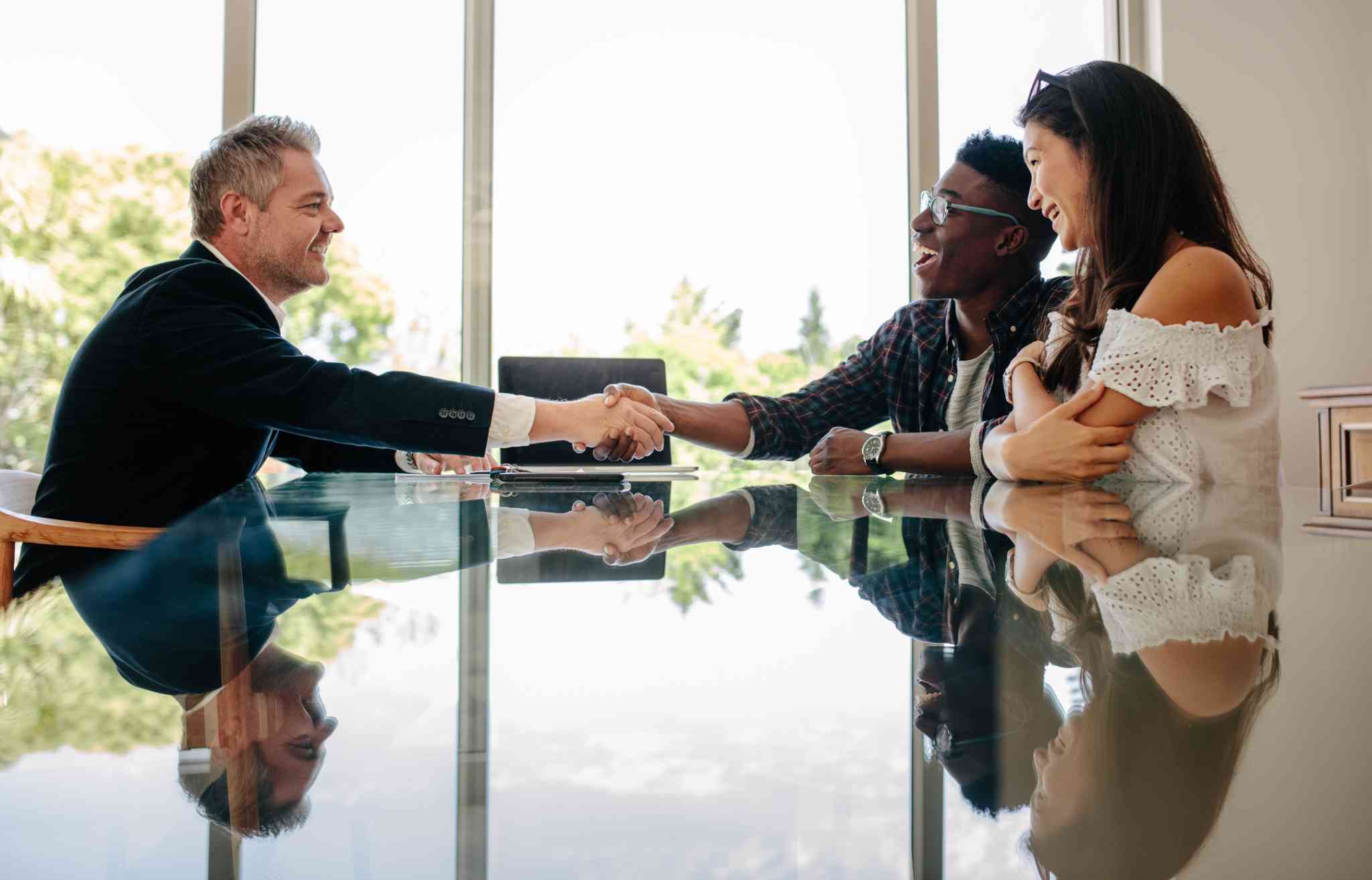 couple making deal with property manager