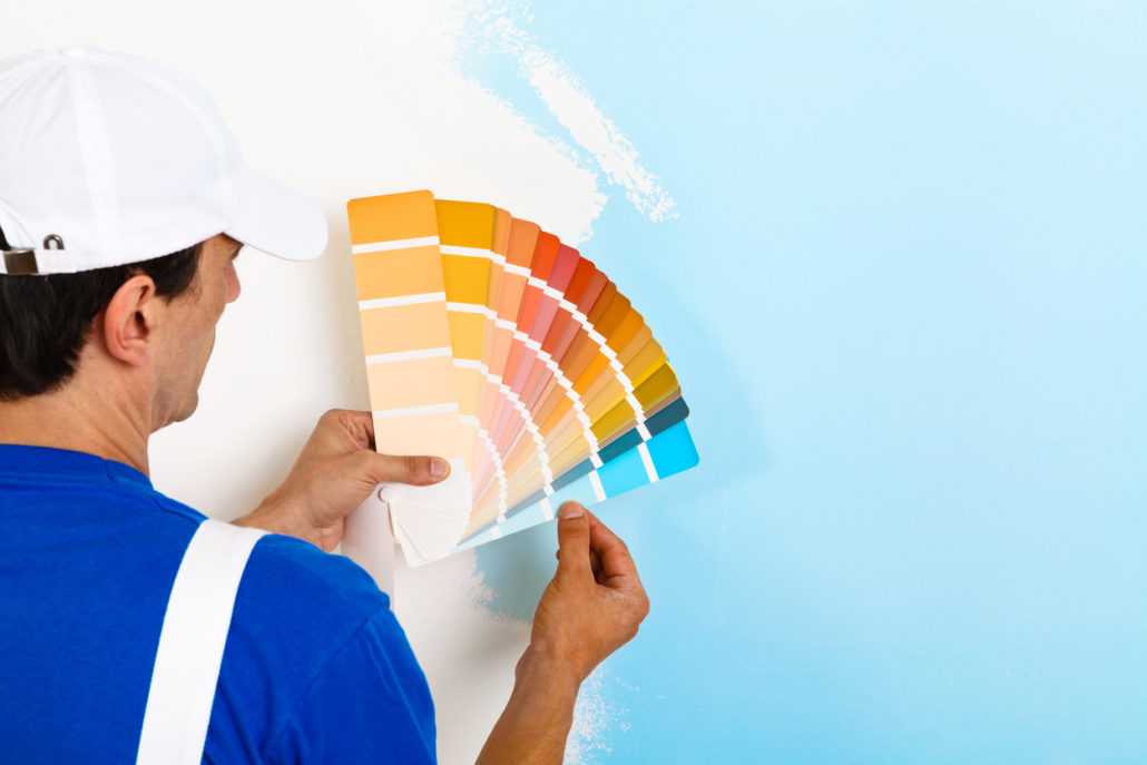 man selecting paint color for wall