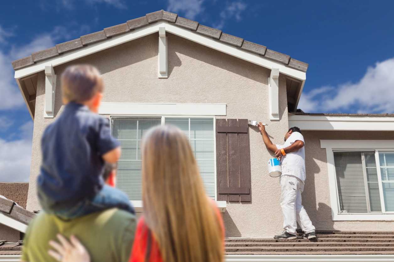 family getting their house exterior painted