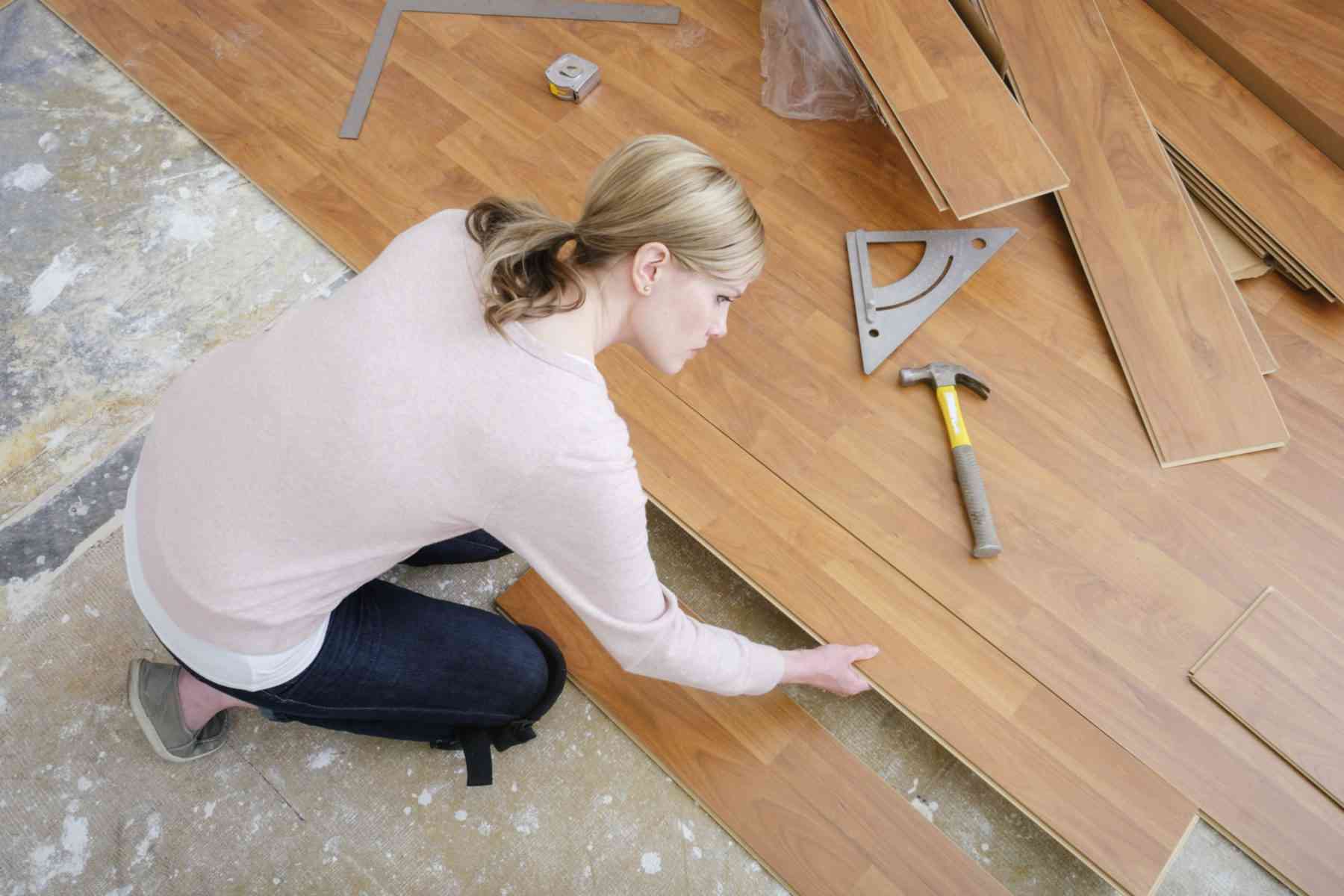 woman installing new flooring