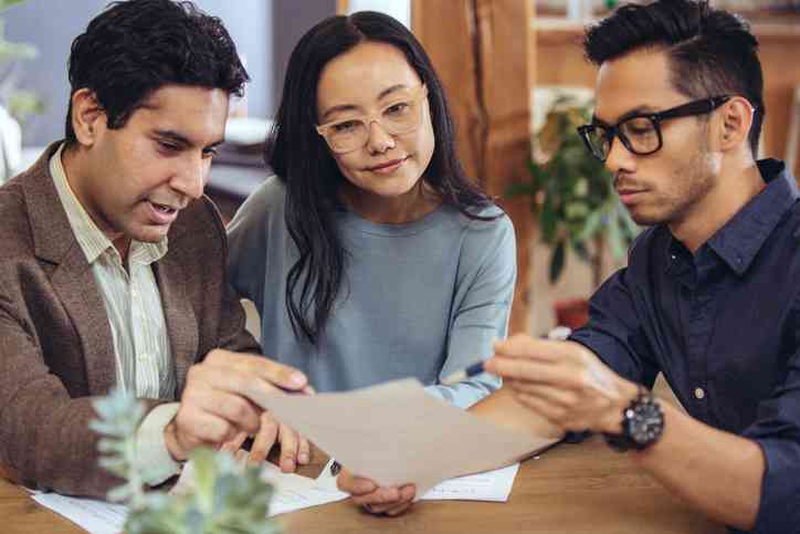 couple making discussion with property sales agent