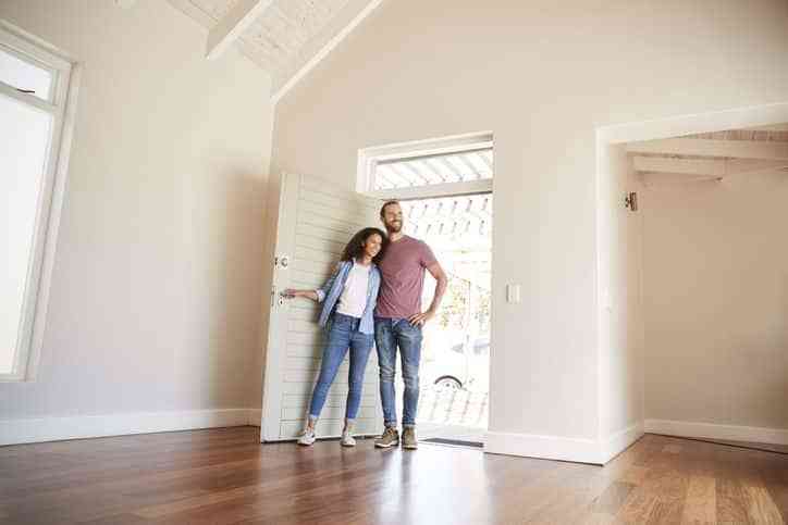 couple visiting new unfurnished home