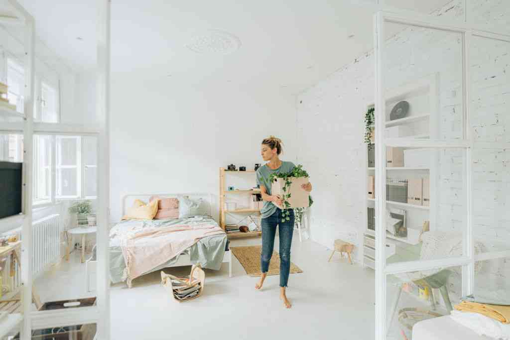 woman setting up bedroom