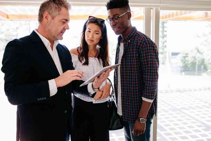 property agent explaining to couple