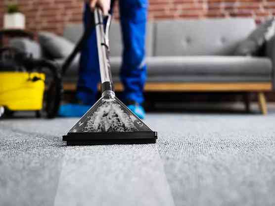 person cleaning carpet