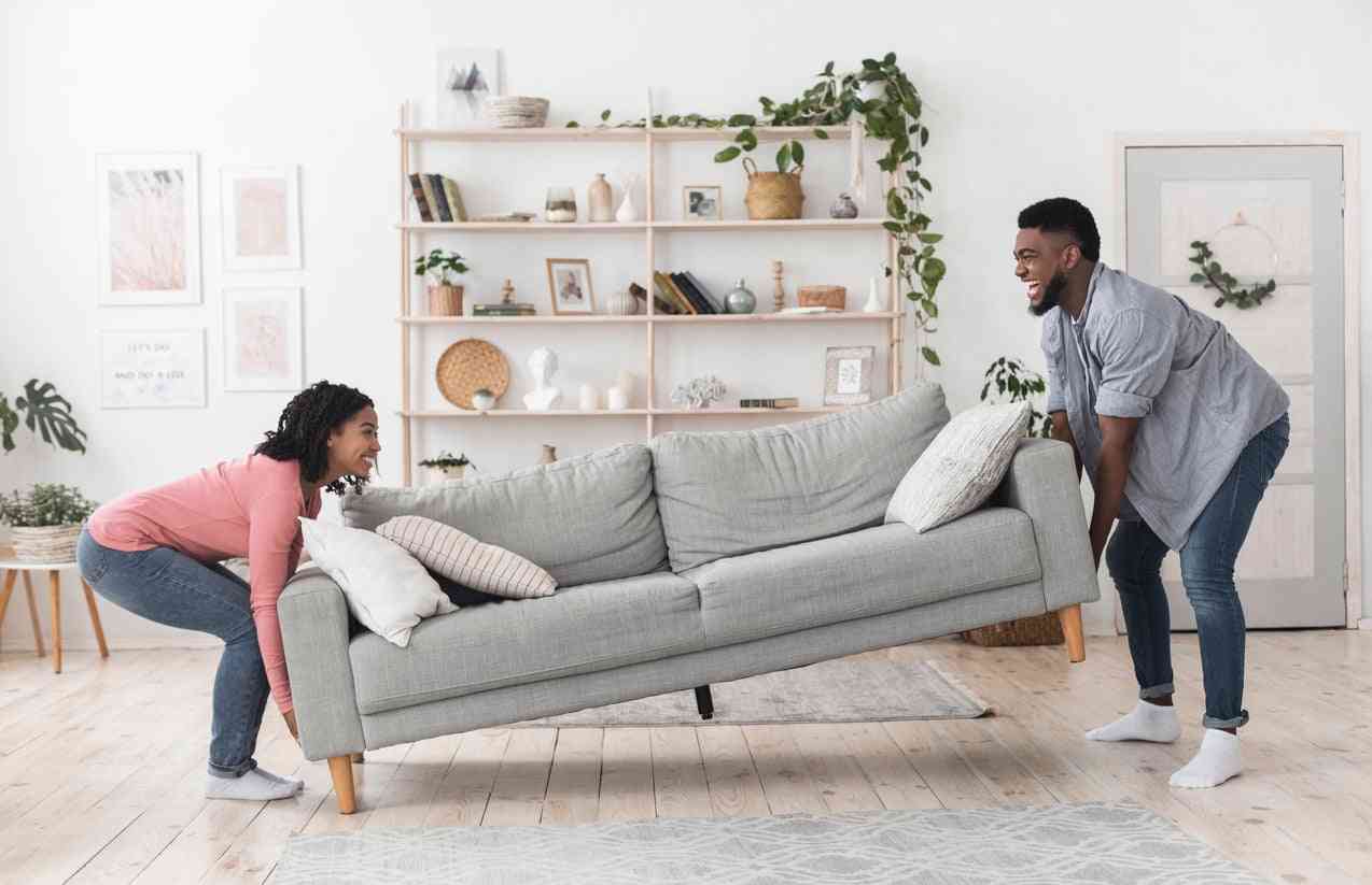 couple lifting couch