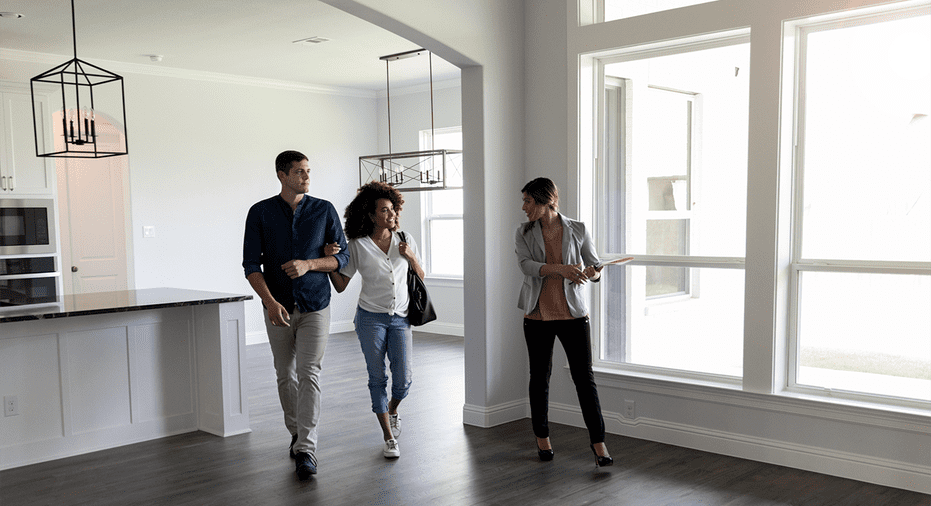 image of couple visiting home with sales agent