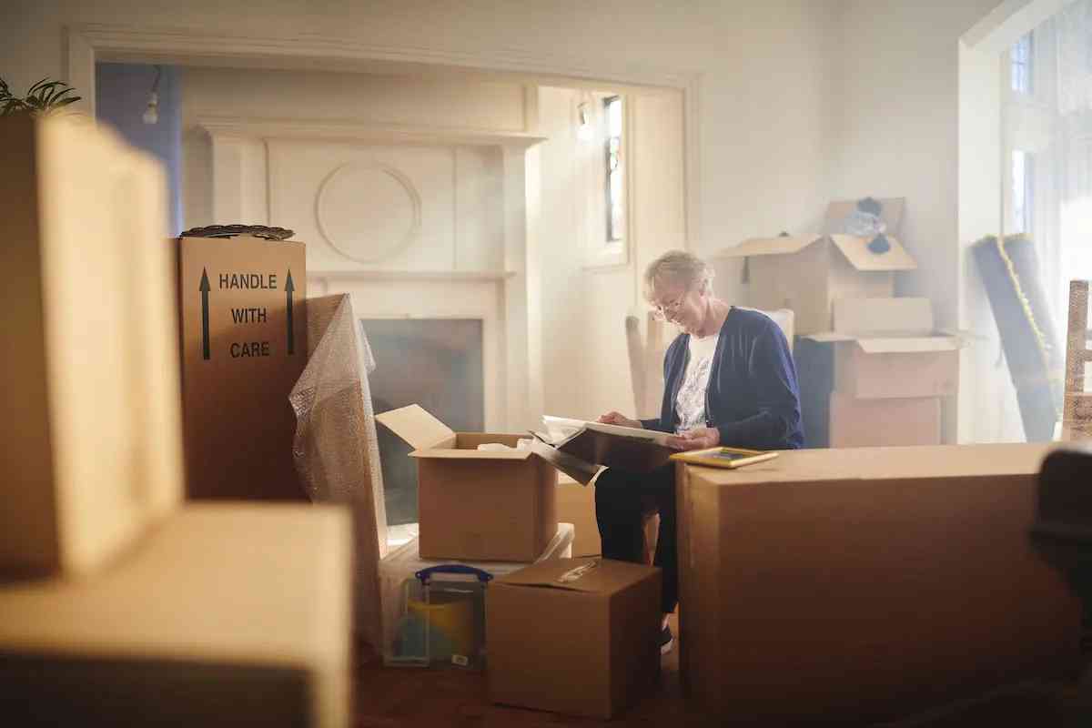 image of woman sitting with packaged boxes