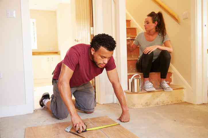 person fixing flooring