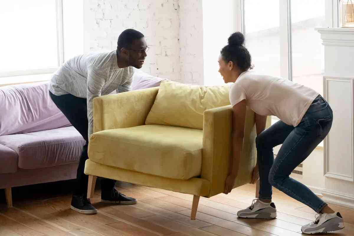 image of couple moving sofa